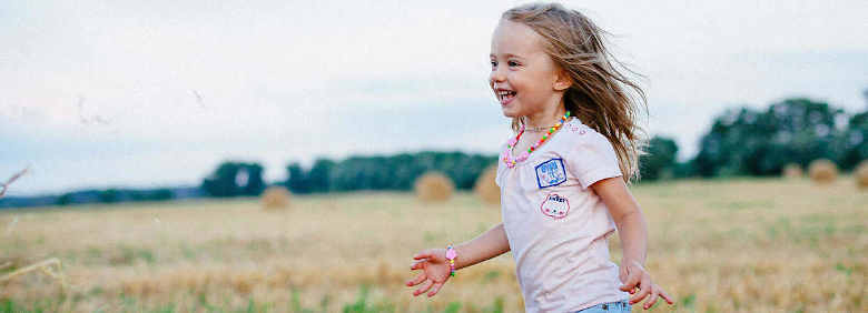 little girl running in the field
